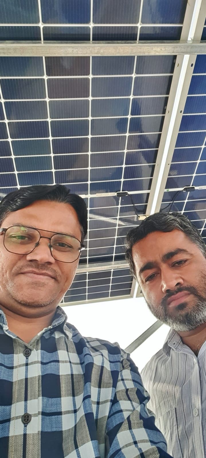 Customer and Genius Solar engineer selfie under rooftop solar panels in Indore